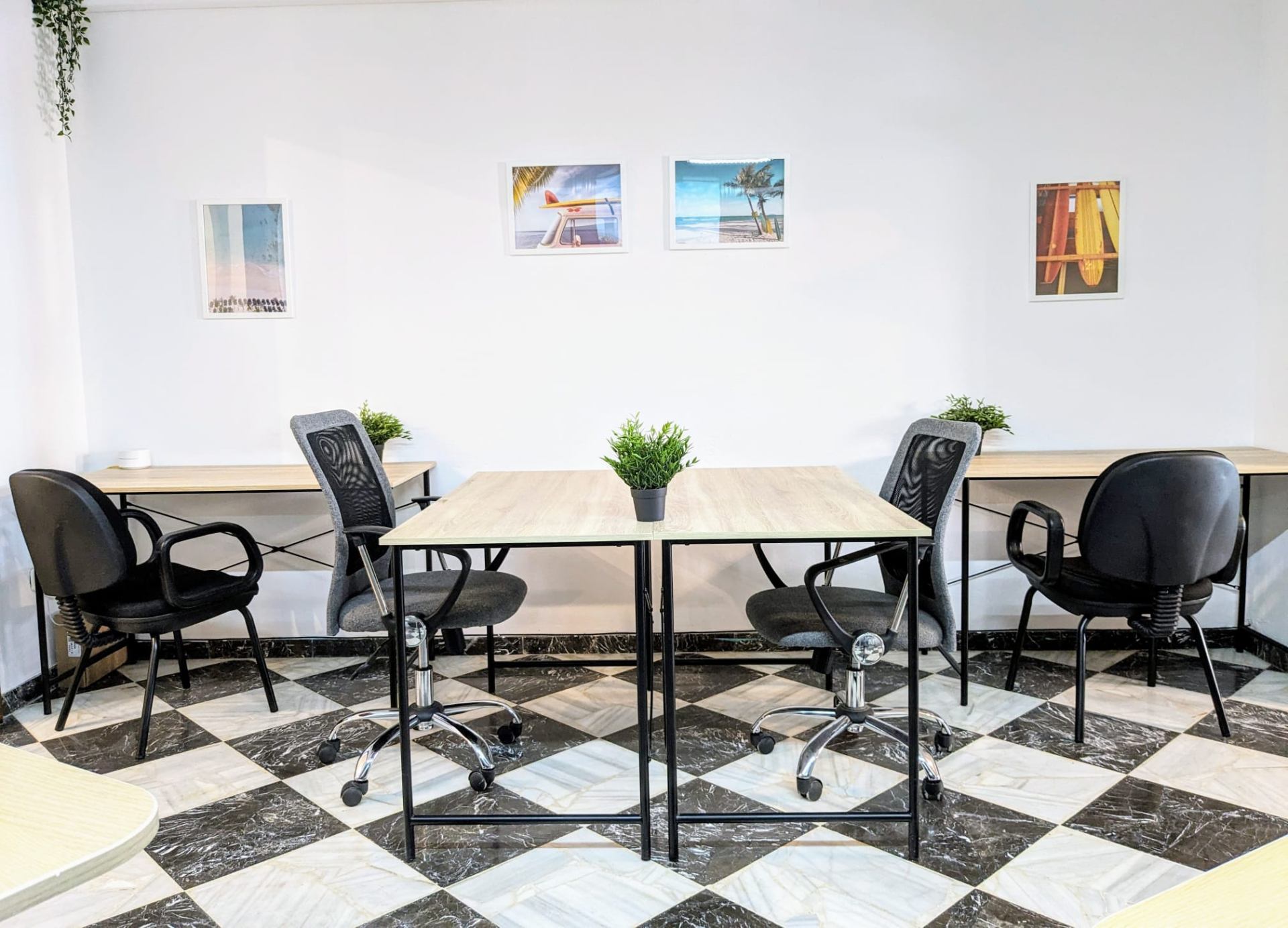 Bright coworking room with desks and ergonomic chairs at BednDesk